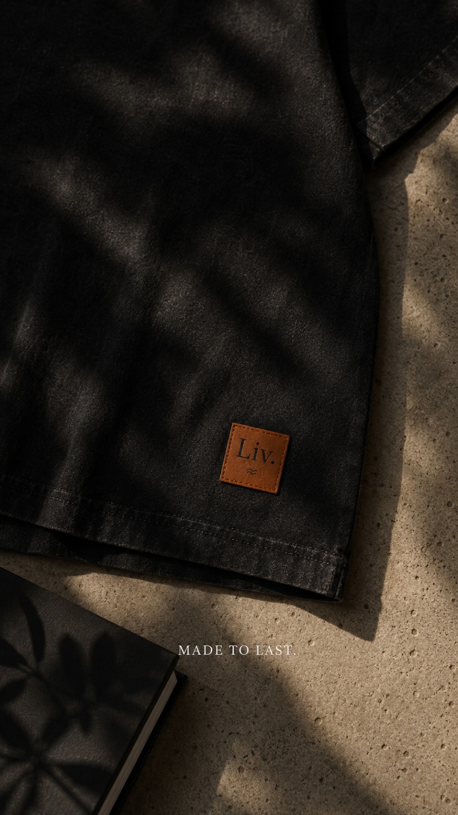 Close-up of the black garment and its leather Liv. patch